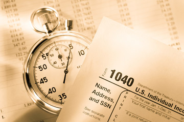 Tax form, operating budget and stopwatch