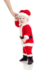 First steps of Santa claus baby. Studio shot