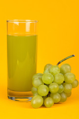 Green fresh juice and grapes