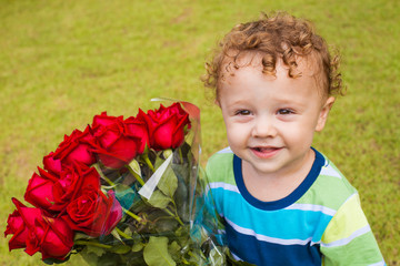 happy child with a bouquet of red roses