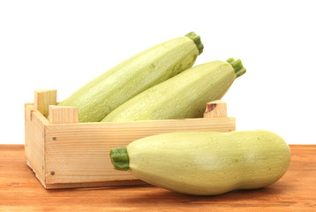 squash in a box on wooden table on white background close-up