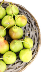 ripe pears on wicker mat isolated on white.