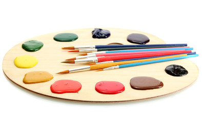 wooden art palette with  paint and brushes.isolated on white