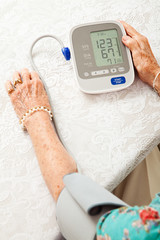 Senior Woman Taking Blood Pressure