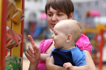 Happy child playing with mother
