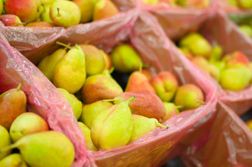 Bunch of fresh pears in boxes in supermarket