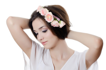 Naklejka premium Portrait of the beautiful girl with flowers in hair