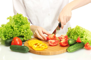 woman hands cutting vegetables on kitchen blackboard
