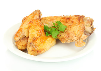 roasted chicken wings and leg with parsley in the plate