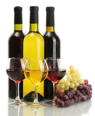 bottles and glasses of wine and ripe grapes isolated on white