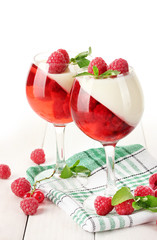 fruit jelly with berries in glasses on wooden table