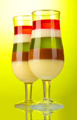 fruit jelly in glasses on green background