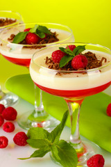 fruit jelly with berries in glasses on green background