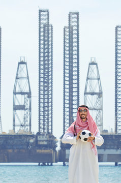 Arab with footbal at seaside