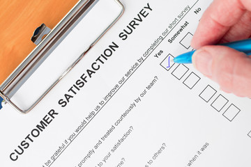 Hand Completing Customer Satisfaction Survey