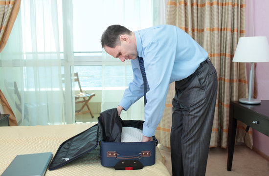 Businessman packing a suitcase