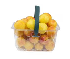 basket full of fresh yellow plums, isolated
