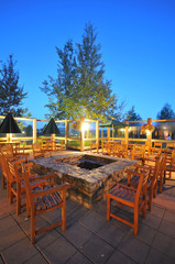 Many chairs around an outdoor fire pit