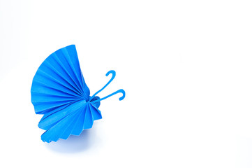Origami Japanese blue paper butterflies on white background.