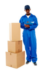 Delivery boy at work. Kindly accept your goods