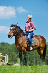 Obraz premium happy woman ride horse