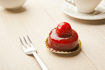 fruit pastry little cake with tea cup on white wooden table