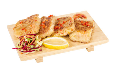 Fried fish fillets with  salad.