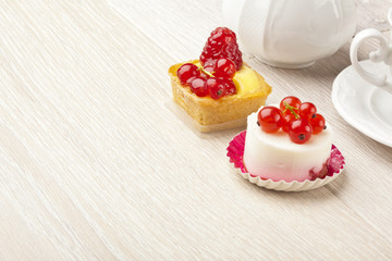 fruit pastry little cake with tea cup on white wooden table