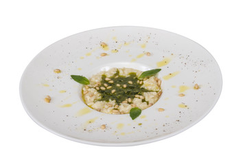 photo of delicious risotto dish with herbs and cedar nut on whit