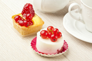 fruit pastry little cake with tea cup on white wooden table