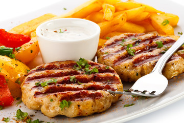 Grilled steaks, French fries and vegetables