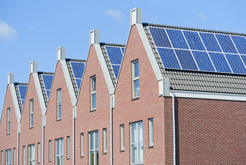 Modern Dutch houses with solar panels on roof