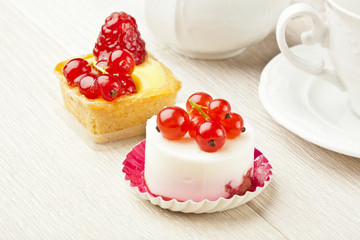 fruit pastry little cake with tea cup on white wooden table