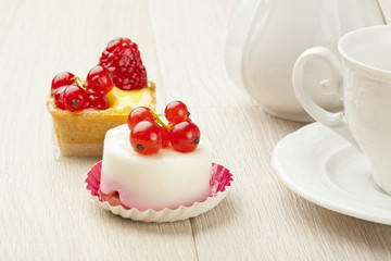 fruit pastry little cake with tea cup on white wooden table