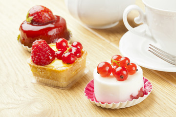 fruit pastry little cake with tea cup on  wooden table