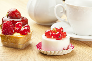 fruit pastry little cake with tea cup on  wooden table