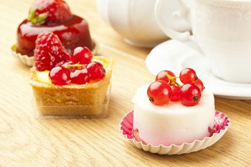 fruit pastry little cake with tea cup on  wooden table