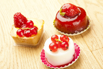 small beautiful red fruit pastry on wooden table