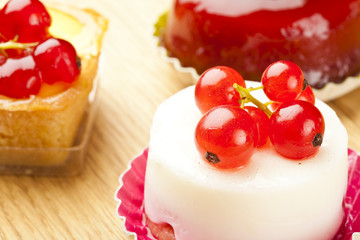small beautiful red fruit pastry on wooden table
