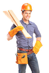 A smiling male carpenter holding sills