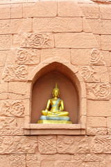 Buddha statue on brick wall