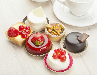 Different sort of beautiful pastry, small colorful sweet cakes