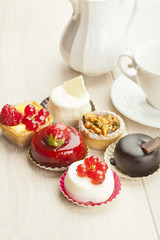 Different sort of beautiful pastry, small colorful sweet cakes