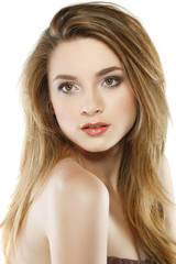 Fototapeta premium A beautiful young woman is in brown clothes on a white 