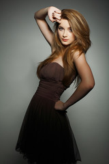 Fototapeta premium A beautiful young woman is in brown clothes