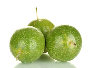 three green passion fruit isolated on white