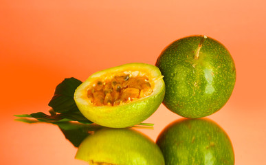 green passion fruit on pink background close-up