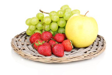 Fototapeta na wymiar ripe sweet fruits and berries on wicker mat isolated on white