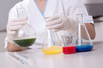 Woman examine colorful bottles fill with chemicals