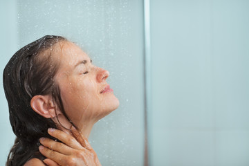 Portrait of woman taking shower - obrazy, fototapety, plakaty